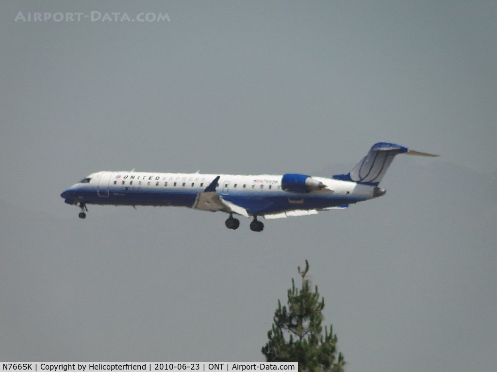 N766SK, 2005 Bombardier CRJ-702 (CL-600-2C10) Regional Jet C/N 10232, United Express operated by Sky West coming out of the haze on final to Ontario