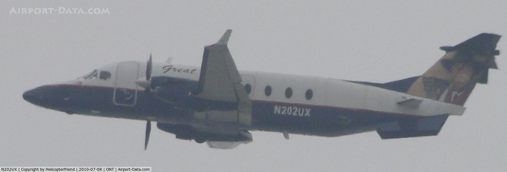 N202UX, 1996 Beech 1900D C/N UE-202, Heading westbound after lift off from runway 26R on a gloomy morning