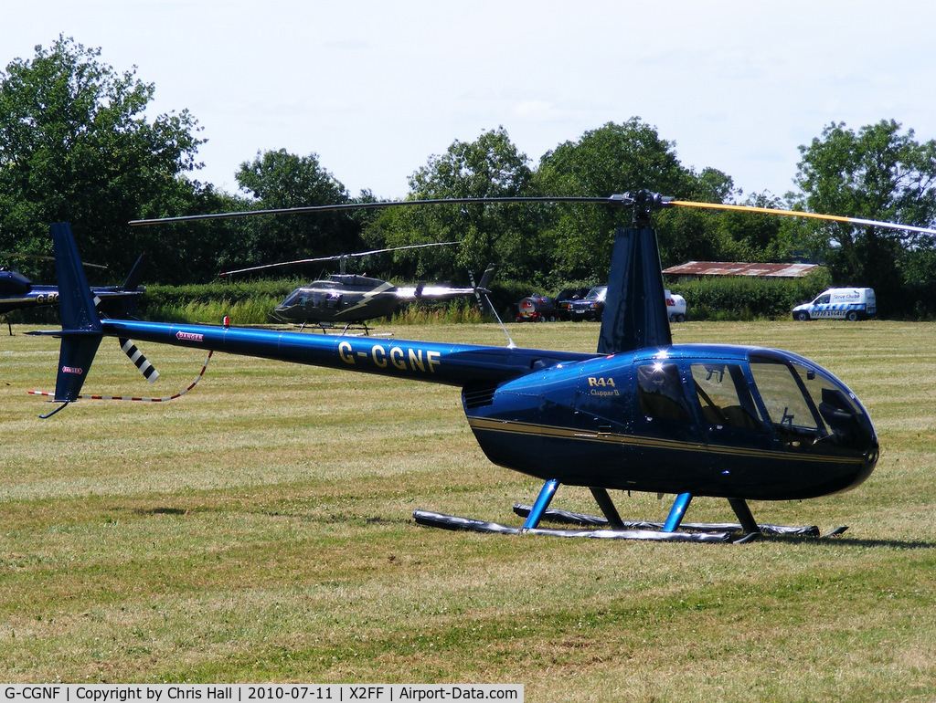 G-CGNF, 2010 Robinson R44 Clipper II C/N 13027, Heli Air Ltd Robinson R44 being used for ferrying race fans to Silverstone for the British Grand Prix from this temporary heliport a few miles east of Bicester