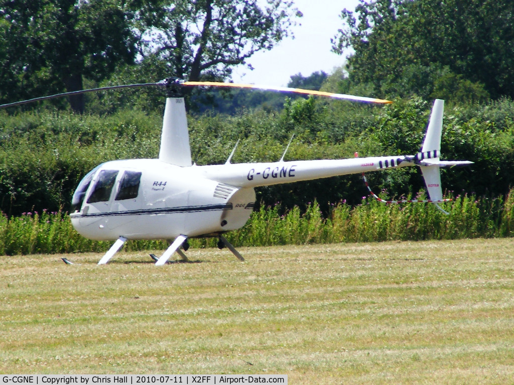G-CGNE, 2010 Robinson R44 Raven II C/N 12952, Robinson R44 being used for ferrying race fans to Silverstone for the British Grand Prix from this temporary heliport a few miles east of Bicester