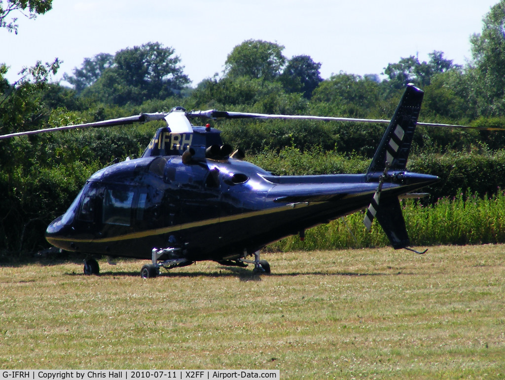 G-IFRH, 1990 Agusta A-109C C/N 7619, Agusta A109C being used for ferrying race fans to Silverstone for the British Grand Prix from this temporary heliport a few miles east of Bicester