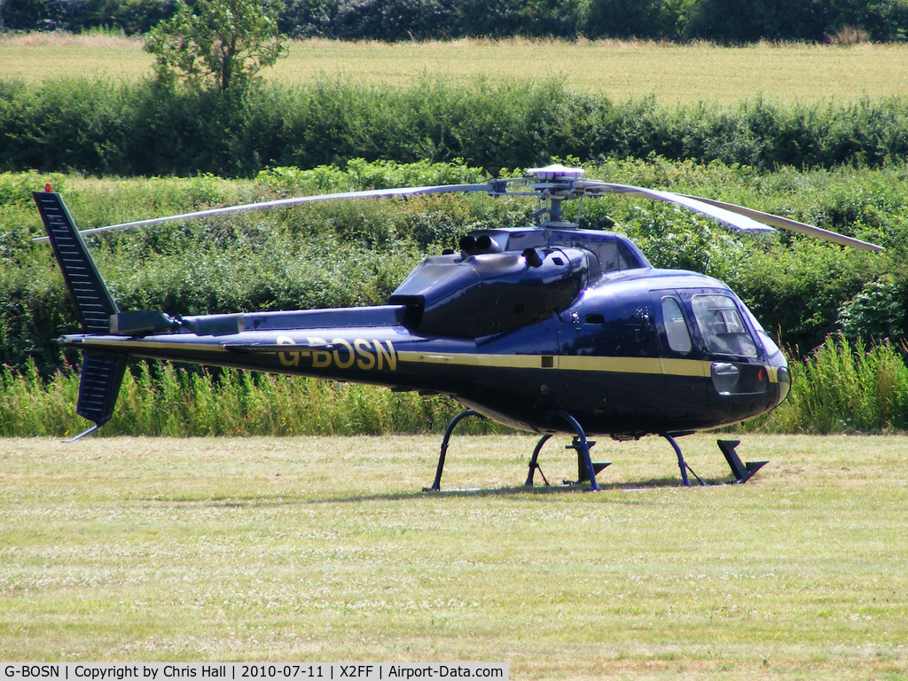 G-BOSN, 1982 Aerospatiale AS-355F-1 Ecureuil 2 C/N 5266, Aerospatiale AS355F1 Ecureuil II being used for ferrying race fans to Silverstone for the British Grand Prix from this temporary heliport a few miles east of Bicester