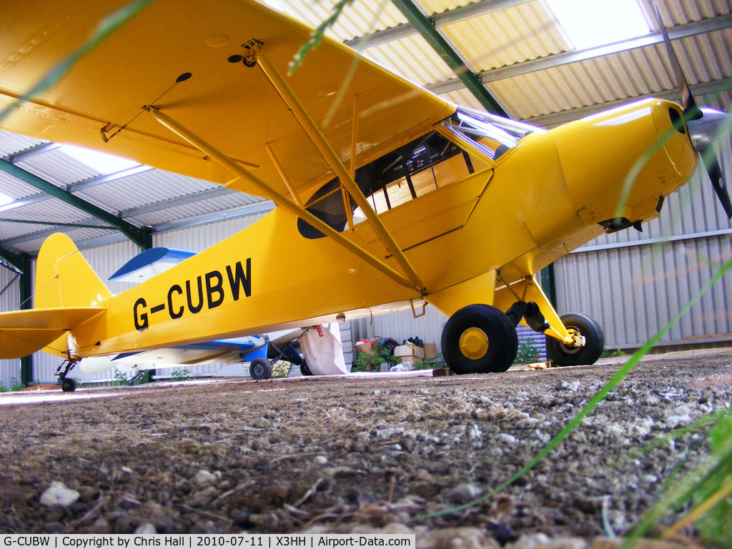 G-CUBW, 2005 Wag-Aero CUBy Acro Trainer C/N PFA 108-13581, shot from under the hangar door at Hinton in the Hedges