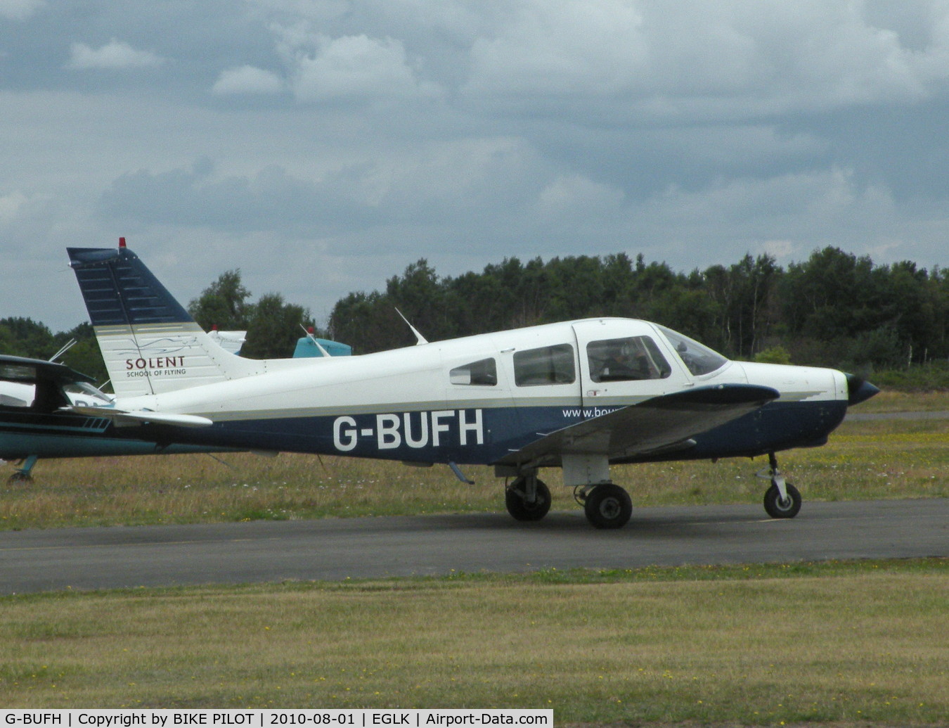 G-BUFH, 1984 Piper PA-28-161 Warrior II C/N 28-8416076, VISITING CHEROKEE TAXYING PAST THE CAFE