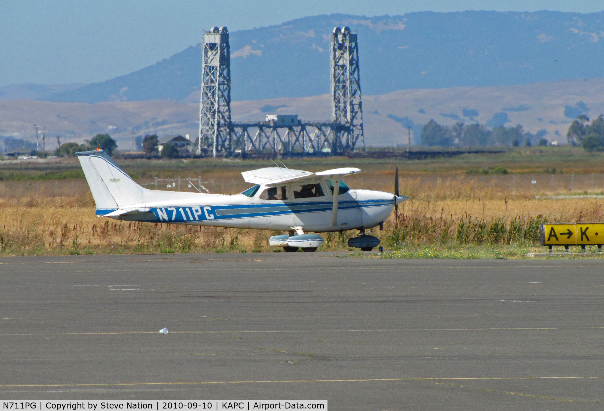 N711PG, Cessna 172M C/N 17264422, Cal Aggie Flying Club Cessna 172M taxiing by Napa River RR bridge for departure to KEDU