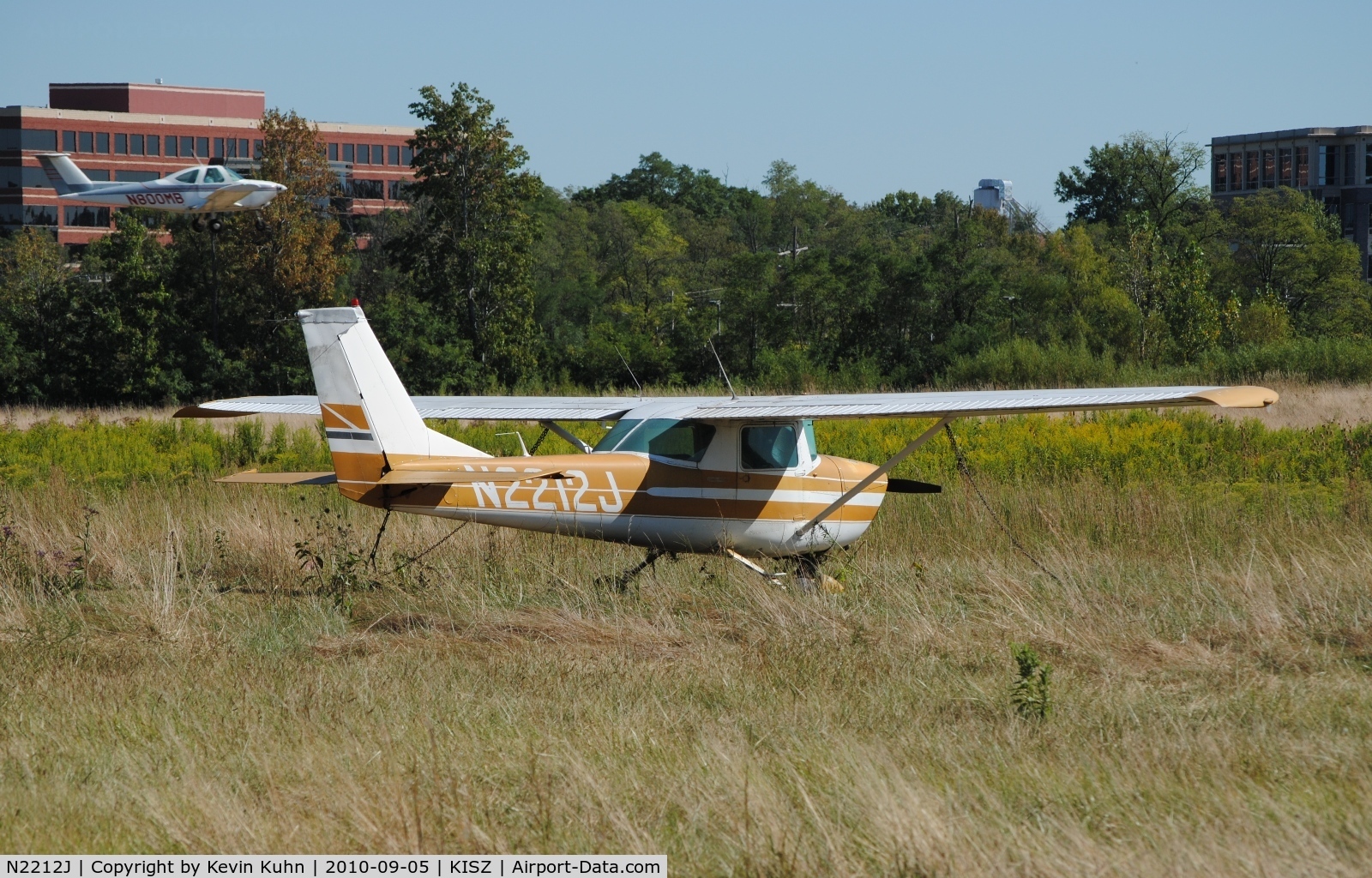 N2212J, 1966 Cessna 150G C/N 15065412, Derelict at Blue Ash. Flamingo Air's Skipper on final in the background.