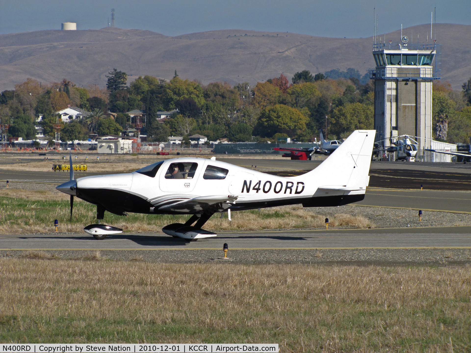 N400RD, 2005 Lancair LC41-550FG C/N 41519, Locally-based 2005 Lancair LC41-550FG Columbia 400 taxiing to RWY 1L with tower in background @ Buchanan Field, Concord, CA