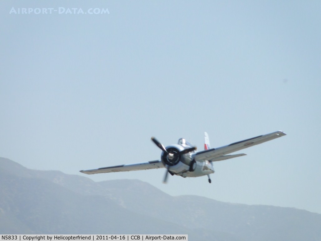 N5833, 1945 General Motors (Grumman) FM-2 Wildcat C/N 5833, Making a wheel up pass while Navion N91707 taxi's off the runway