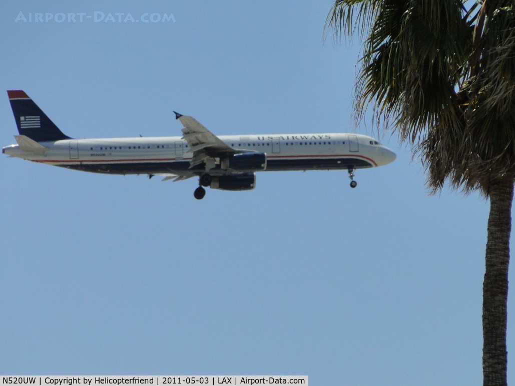 N520UW, 2009 Airbus A321-231 C/N 3924, 1/2 miles east of LAX on final to runway 24, ready to pass south of the trees