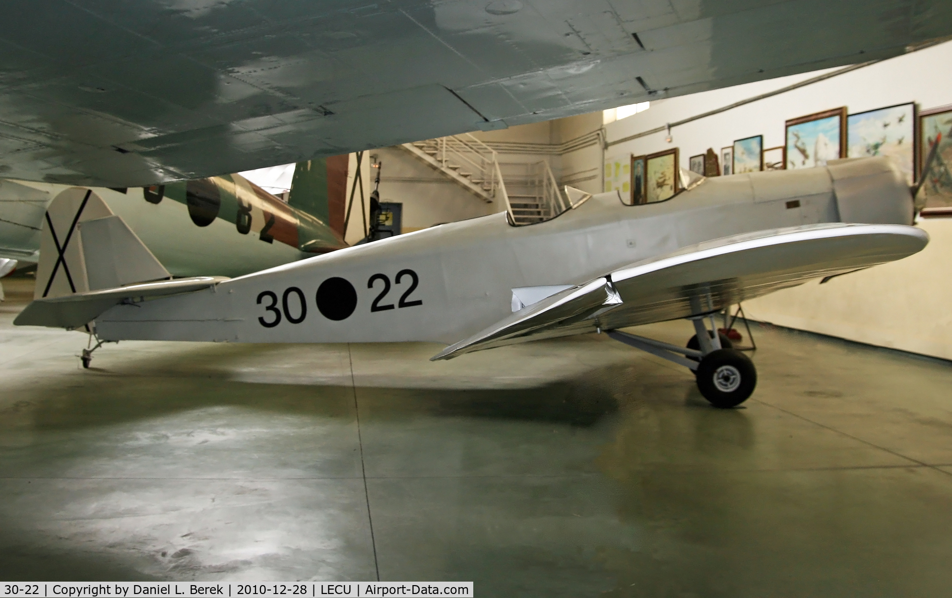 30-22, Klemm L25B I C/N 277, The massive wing of a Heinkel He-111 frames this diminutive trainer.  Former registration was D-ANAE or D-ANAF.