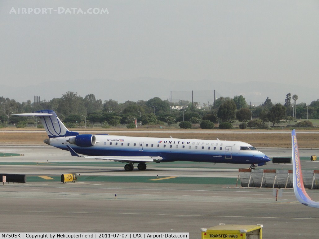 N750SK, 2005 Bombardier CRJ-701ER (CL-600-2C10) Regional Jet C/N 10207, United Express taxiing to runway 24L for take off