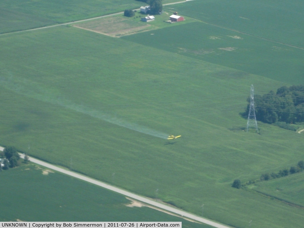 UNKNOWN, Miscellaneous Various C/N unknown, Crop duster flying under power lines in northern Indiana.