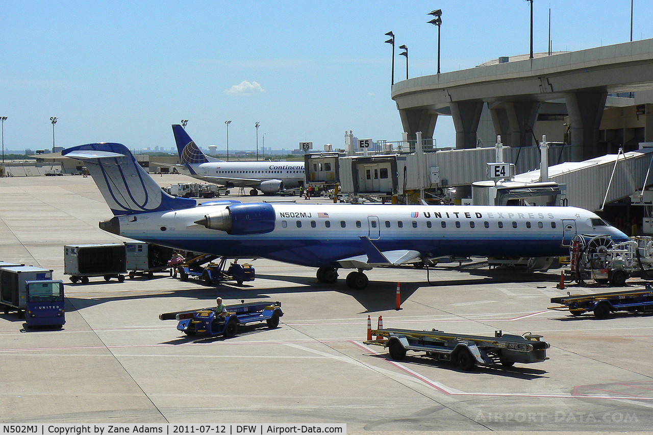 N502MJ, 2002 Bombardier CRJ-700 (CL-600-2C10) Regional Jet C/N 10050, United Express at the gate - DFW Airport