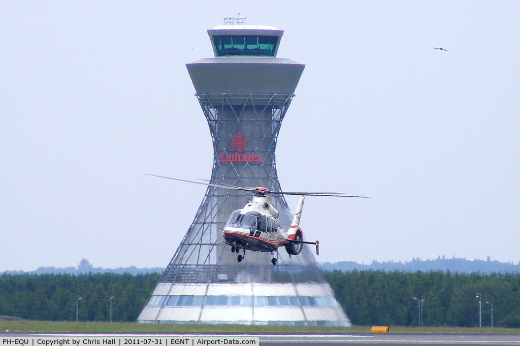 PH-EQU, 2005 Eurocopter EC-155B-1 C/N 6708, in a hover taxi with Newcastle's impressive ATC Tower in the background