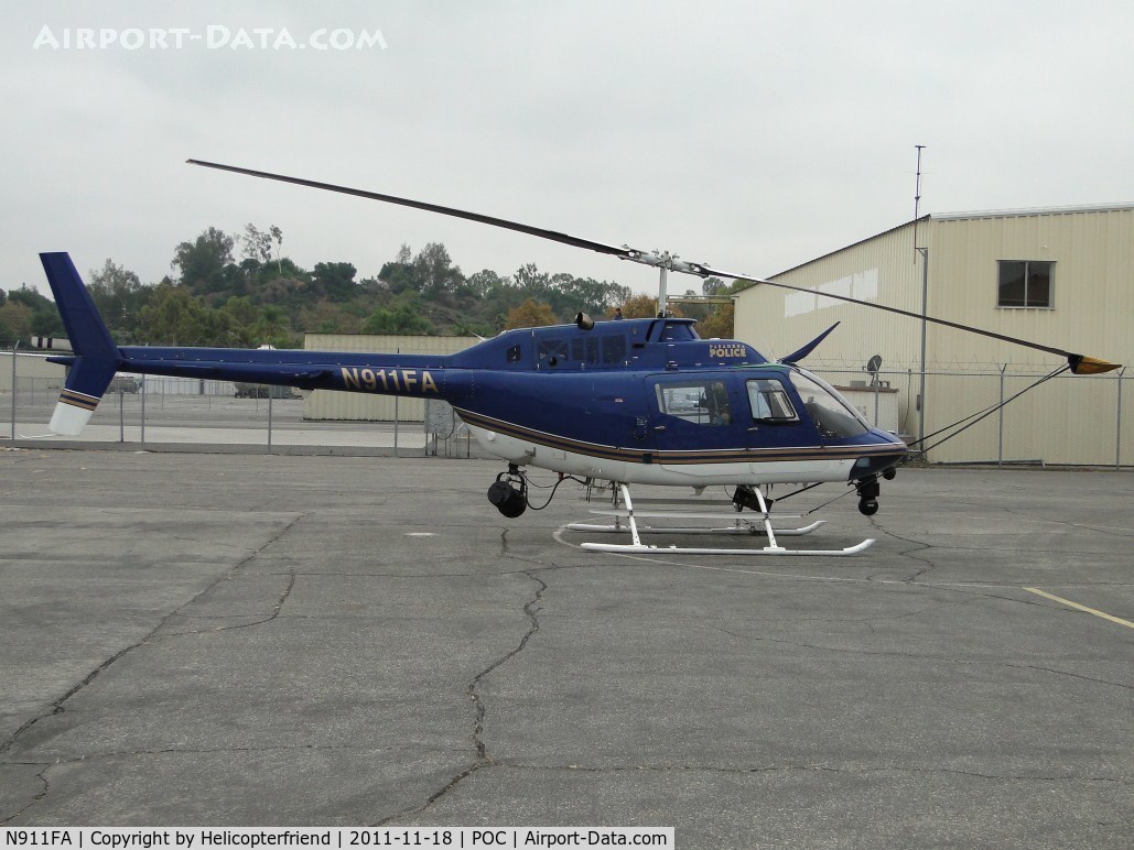 N911FA, Bell OH-58A Kiowa C/N 70-15152, Parked in Pomona PD hanger's fenced helipad