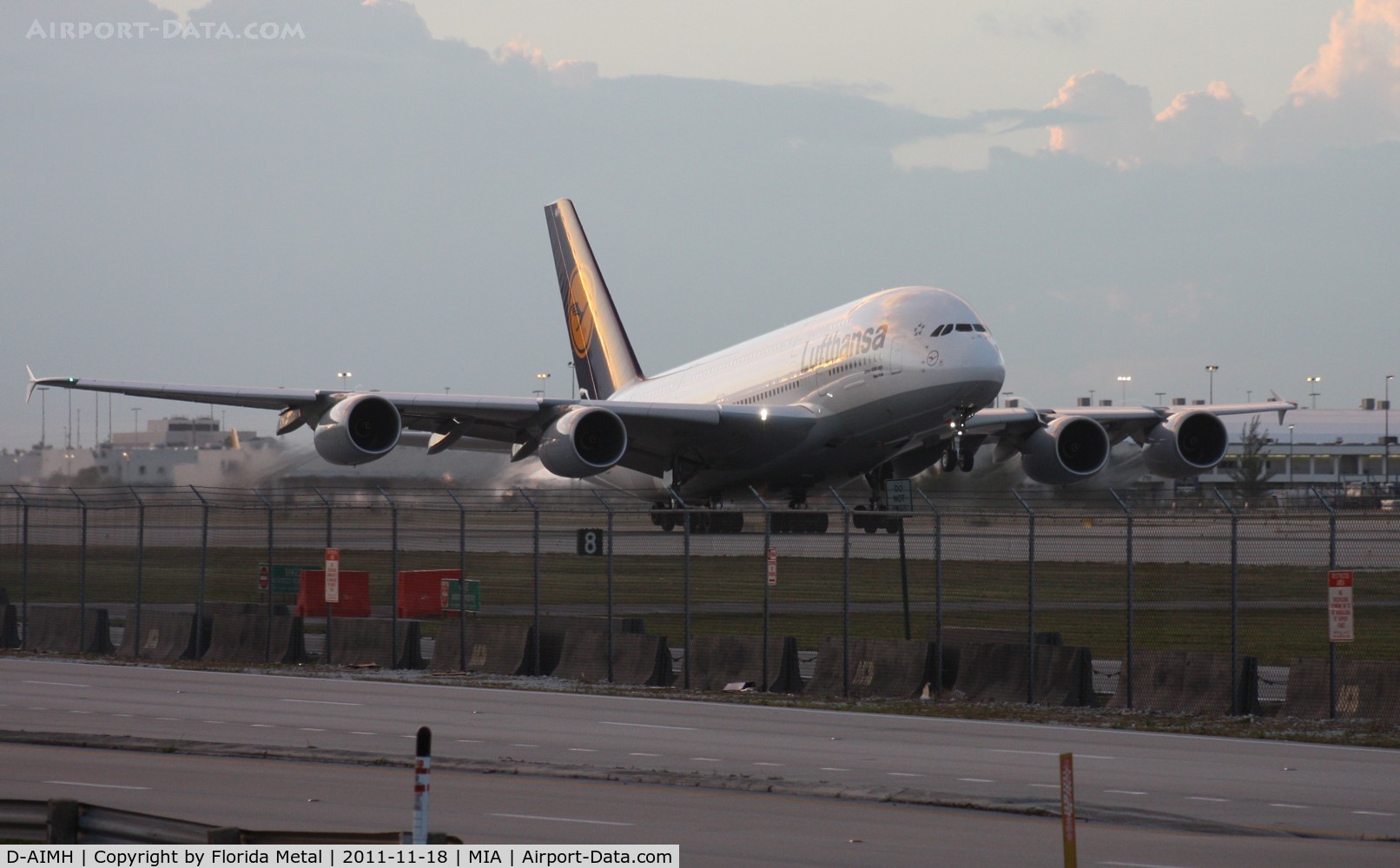 D-AIMH, 2010 Airbus A380-841 C/N 070, Lufthansa A380 taking off at dusk.  I went down to 94th Aero Squadron to get this.  I am standing on the back of my car as a cop on Perimeter Rd is signaling for me to get down.
