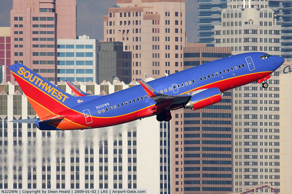 N222WN, 2005 Boeing 737-7H4 C/N 34290, Southwest Airlines N222WN (FLT SWA297) climbing out from RWY 1R, with a nice backdrop of the NY, NY Hotel and Casino, en route to Phoenix Sky Harbor Int'l (KPHX).
