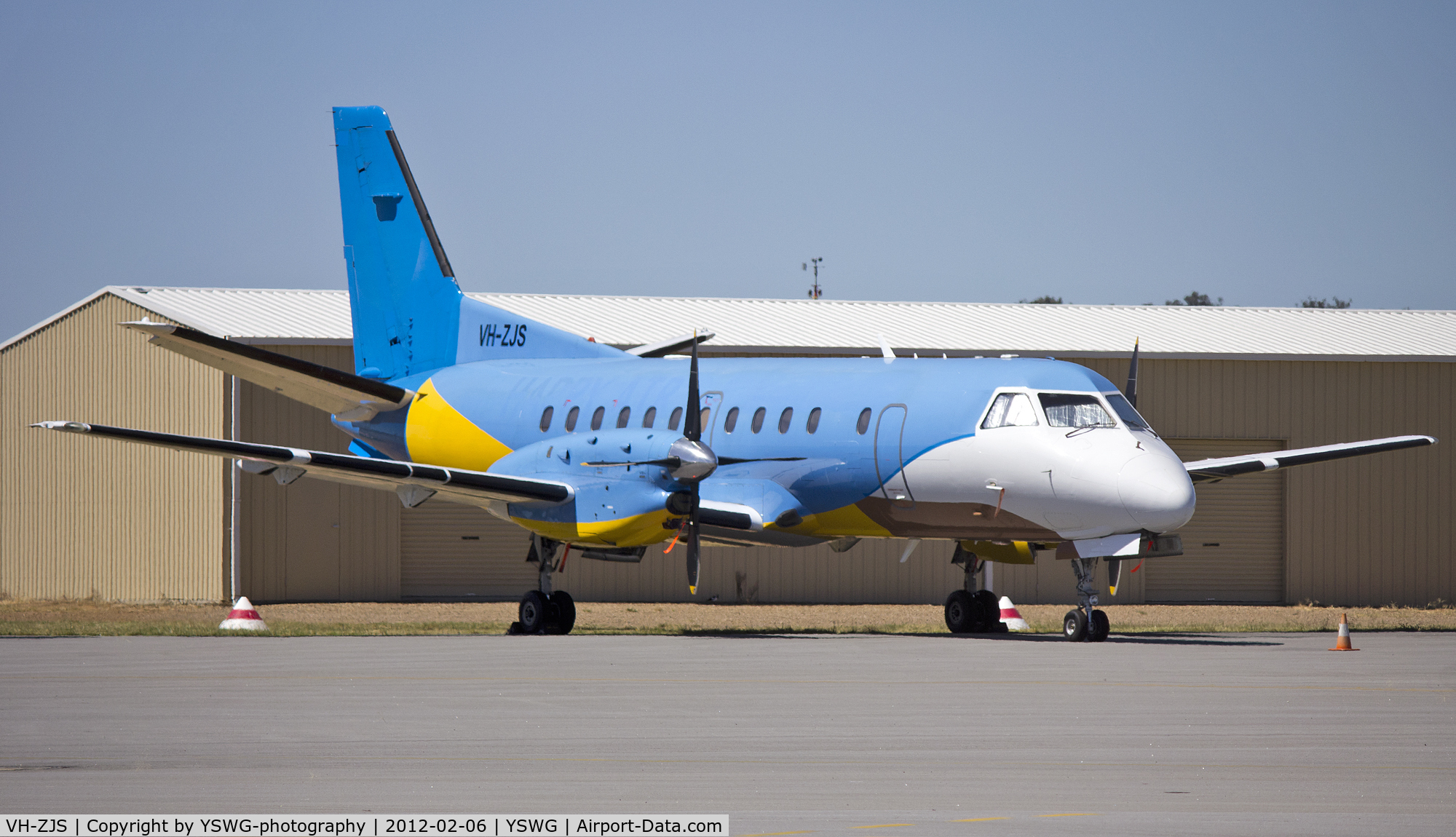 VH-ZJS, 1990 Saab 340B C/N 340B-186, Regional Express Holdings Limited, Saab 340B (VH-ZJS) in former Happy Air Travellers livery, on the tarmac at Wagga Wagga Airport.
