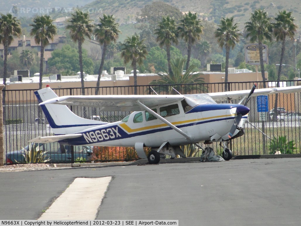N9663X, 1962 Cessna 210B C/N 21057963, Parked between the hangers at the fence