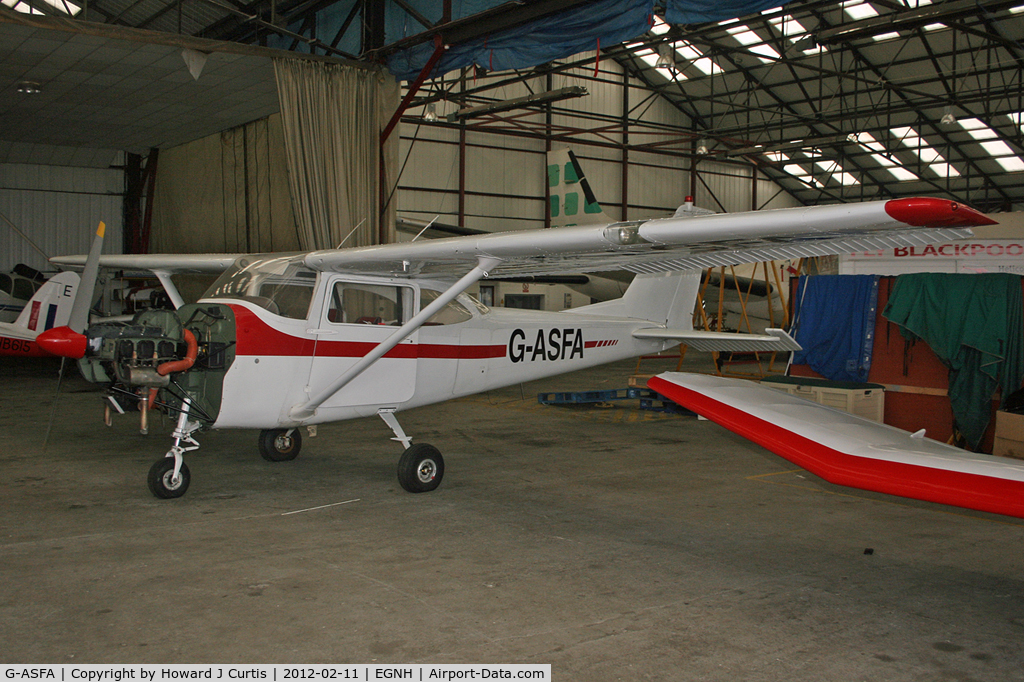 G-ASFA, 1963 Cessna 172D C/N 17250182, Hangared with the engine cowling off.