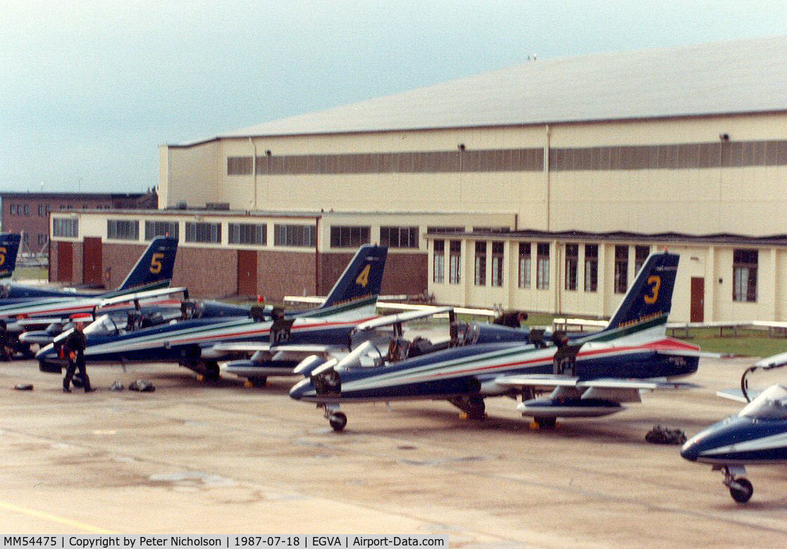 MM54475, Aermacchi MB-339MB C/N 6670, MB-339B, callsign India 4477, number 3 of the Italian Air Force's Frecce Tricolori aerobatic team with others on the flight-line at the 1987 Intnl Air Tattoo at RAF Fairford.