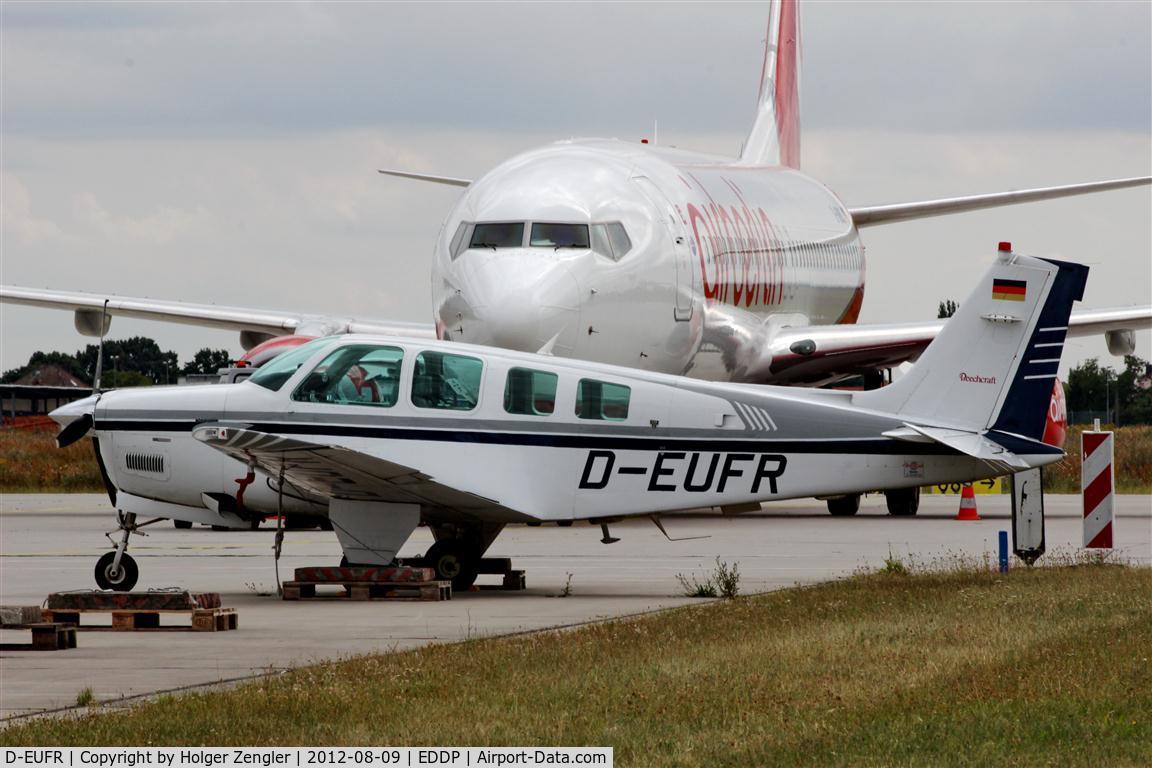 D-EUFR, Raytheon Aircraft Company A36 Bonanza C/N E-3021, Resting in the shadow of something bigger.....