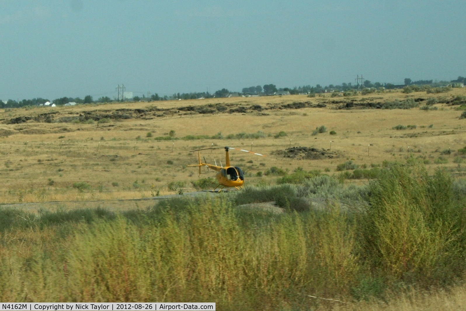 N4162M, 2008 Robinson R44 C/N 1877, Parked along HWY 93 and Golfcourse rd. just north of Twin Falls Id.