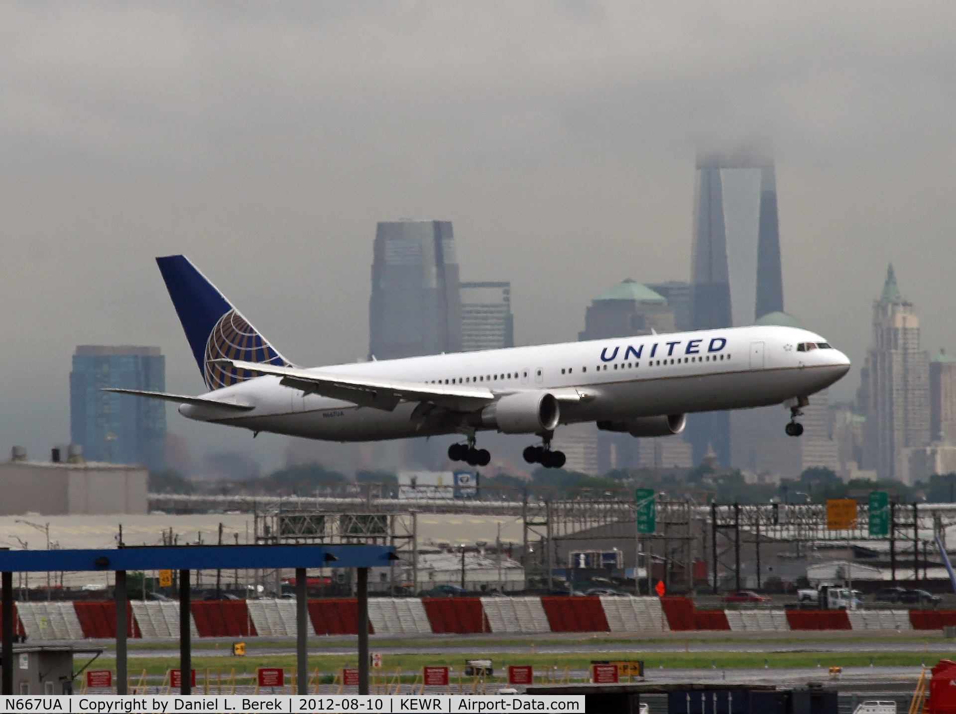 N667UA, 1998 Boeing 767-322 C/N 29239, The stormy sky and Manhattan skyline provide a dramatic backdrop as this UA Boeing 767 battles bad weather and strong winds to land on Newark's shortest runway.