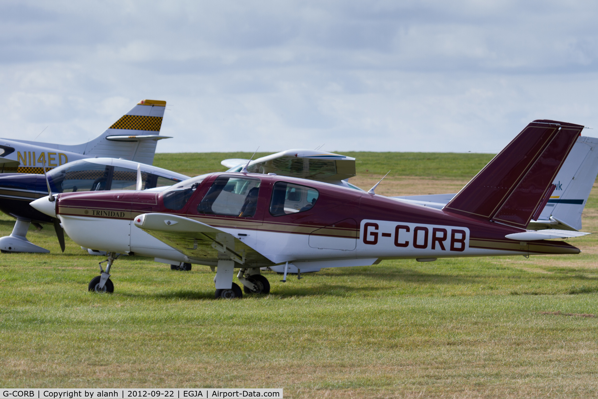 G-CORB, 1990 Socata TB-20 Trinidad C/N 1178, Parked with visitors at the Alderney Air Races, 2012