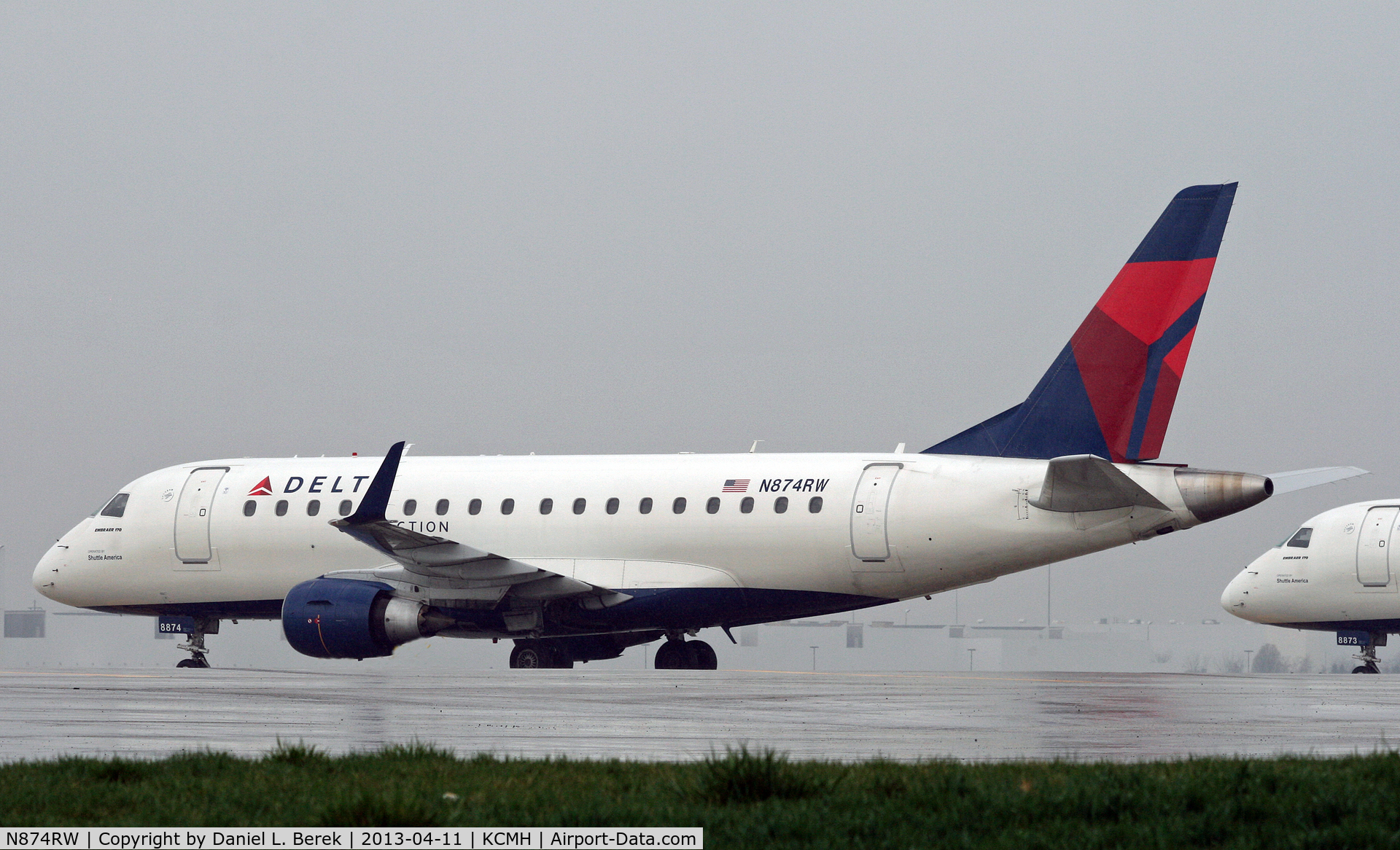 N874RW, 2006 Embraer 170SU (ERJ-170-100SU) C/N 17000148, A Delta Connection ERJ sits it out at a remote corner on a very wet day in Columbus.