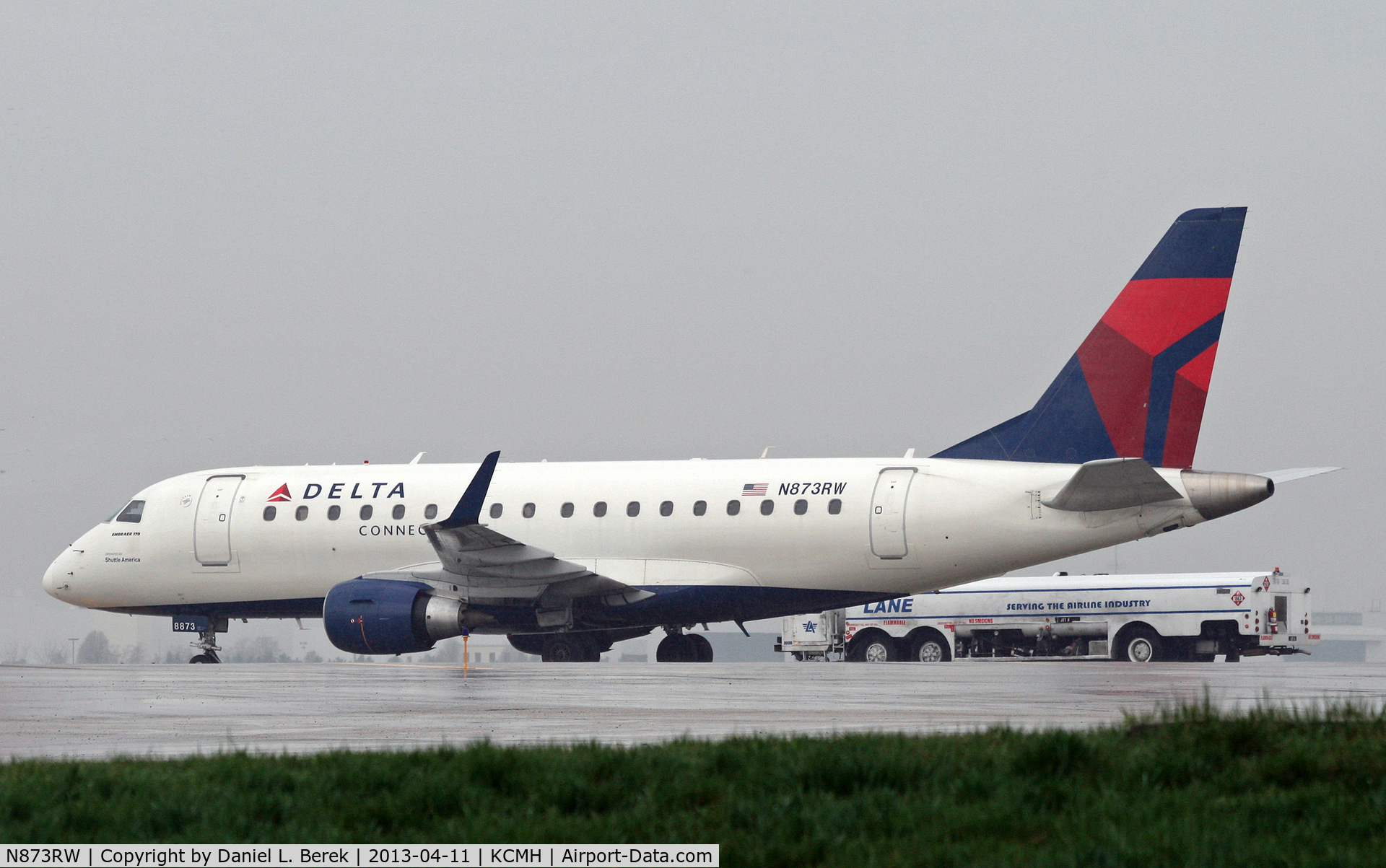 N873RW, 2006 Embraer 170SU (ERJ-170-100SU) C/N 17000144, Formerly in Midwest colors, this regional jet now serves Delta Connection.  She sits out a rain storm on a remote stand at Port Columbus International.