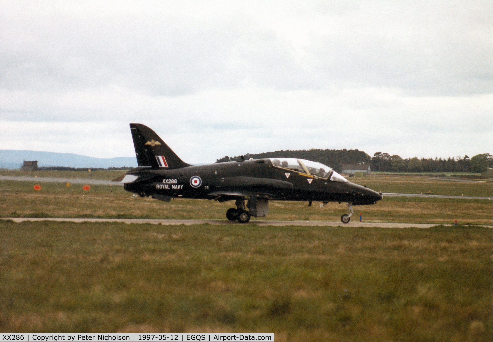 XX286, 1979 Hawker Siddeley Hawk T.1A C/N 112/312111, Hawk T.1A of the Royal Navy's Fleet Requirements & Direction Unit (FRADU) awaiting clearance to join the active runway at RAF Lossiemouth in May 1997.