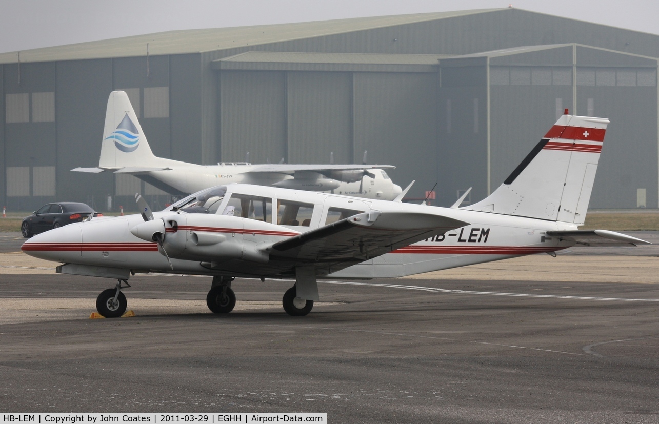 HB-LEM, 1973 Piper PA-34-200 Seneca C/N 34-7350327, Parked at BHL with Oil Spill Herc EI-JIV in background