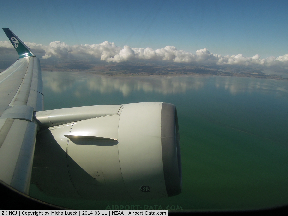 ZK-NCJ, 1995 Boeing 767-319/ER C/N 26915, The clouds mirror in the water of Manuaku Harbour as we climb out of AKL enroute to HNL