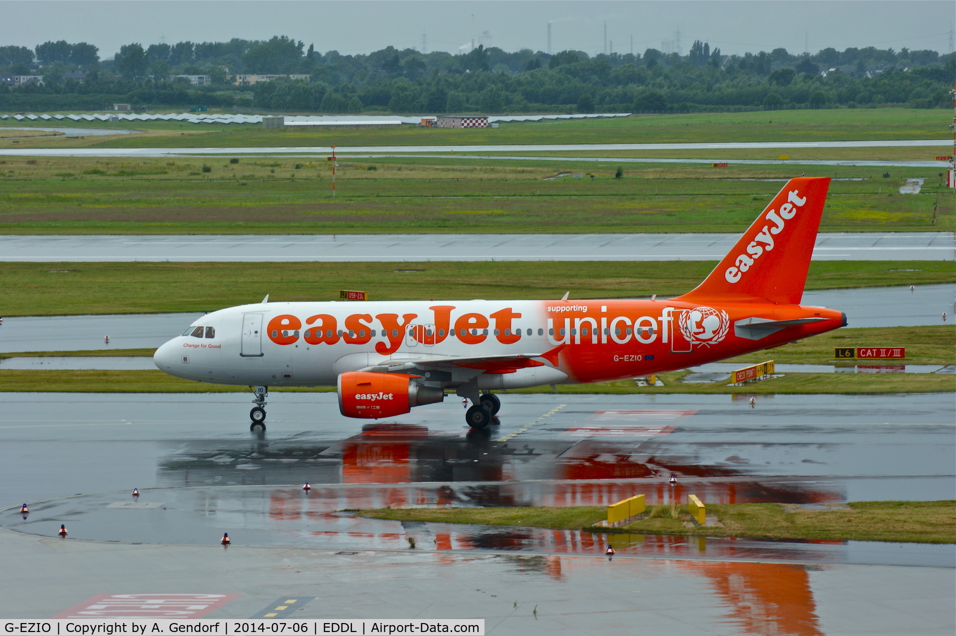 G-EZIO, 2005 Airbus A319-111 C/N 2512, Easy Jet (Unicef cs.), see the reflections on the wet taxiway