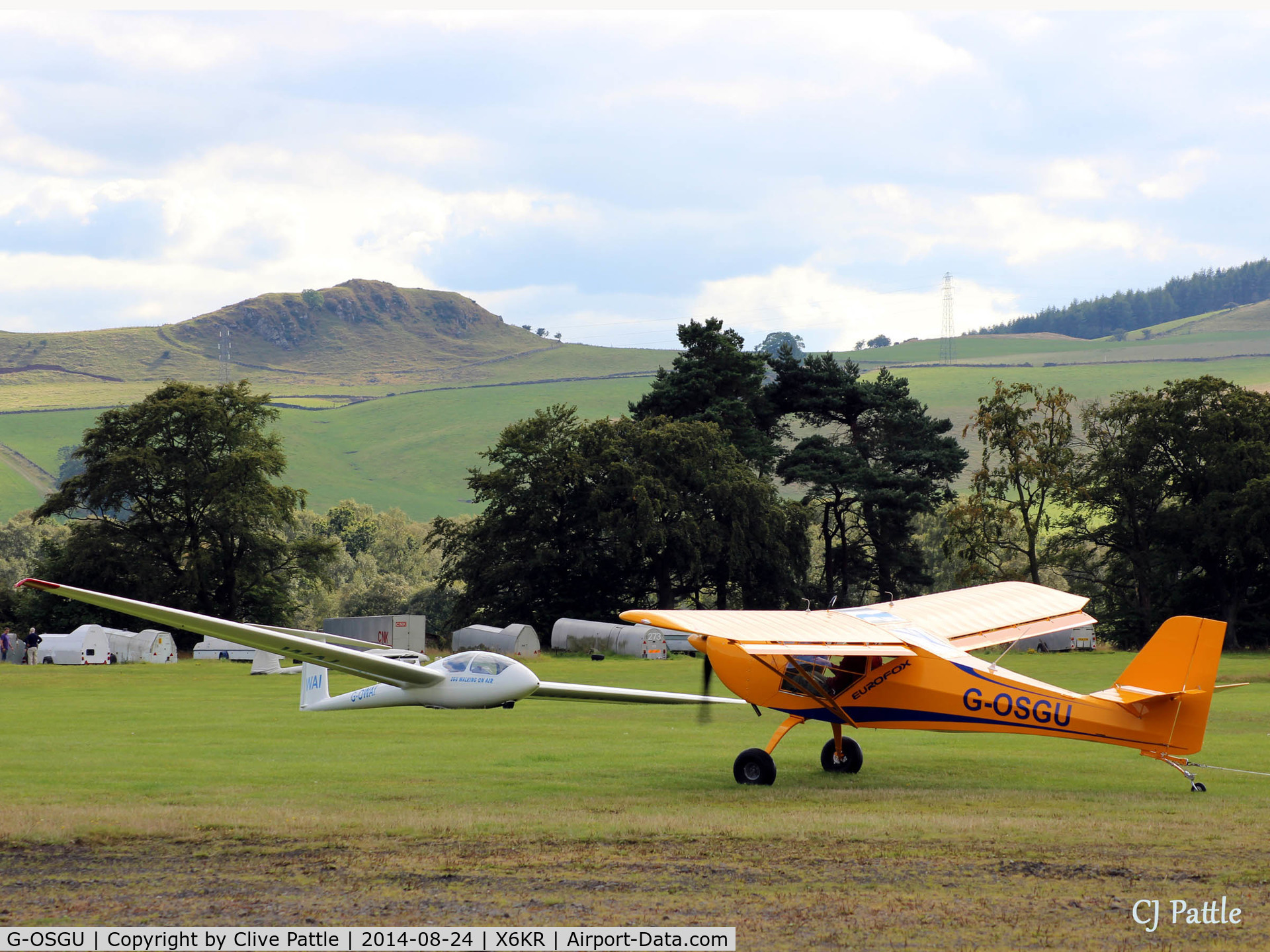 G-OSGU, 2014 Aeropro Eurofox 912(S) C/N LAA 376-15214, Busy scene at Portmoak Gliding Field, Kinross, Scotland, 'GU taxies towards its hangar still trailing its glider tow line.
