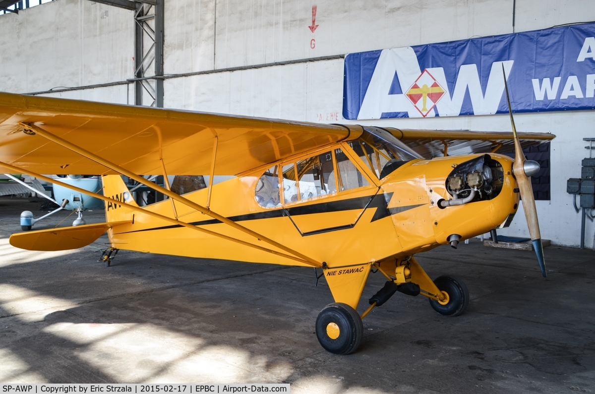 SP-AWP, Piper L-4B Grasshopper C/N 10123, SP-AWP in aan aircraft hangar, that belongs to Warsaw Aeroclub.