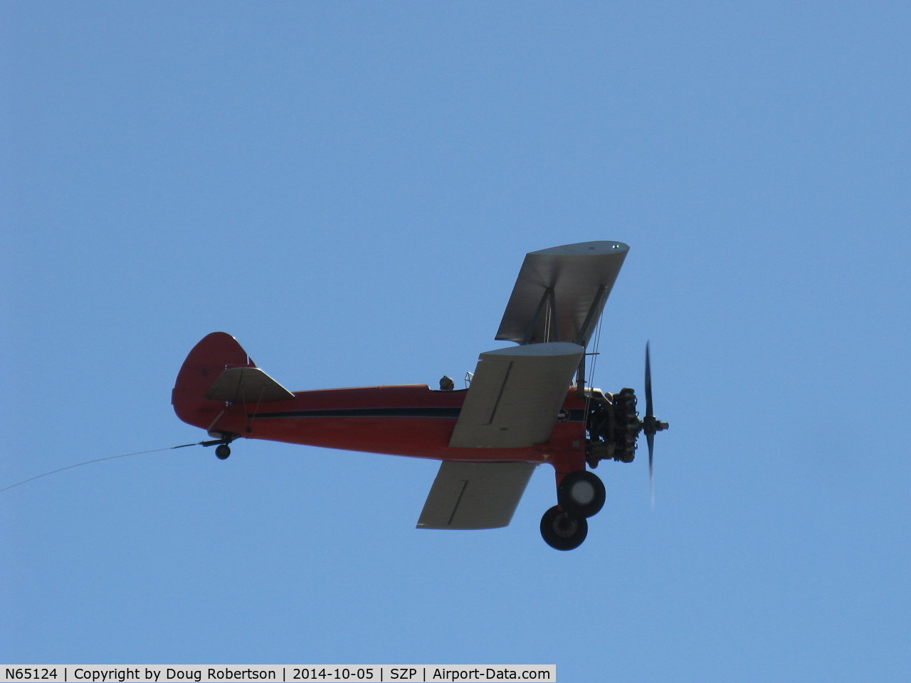 N65124, 1943 Boeing A75N1(PT17) C/N 75-1260, Banner Tow sequence by N65124 Boeing Stearman, banner drop on 22L and fly away. Note towline. End of sequence photo.