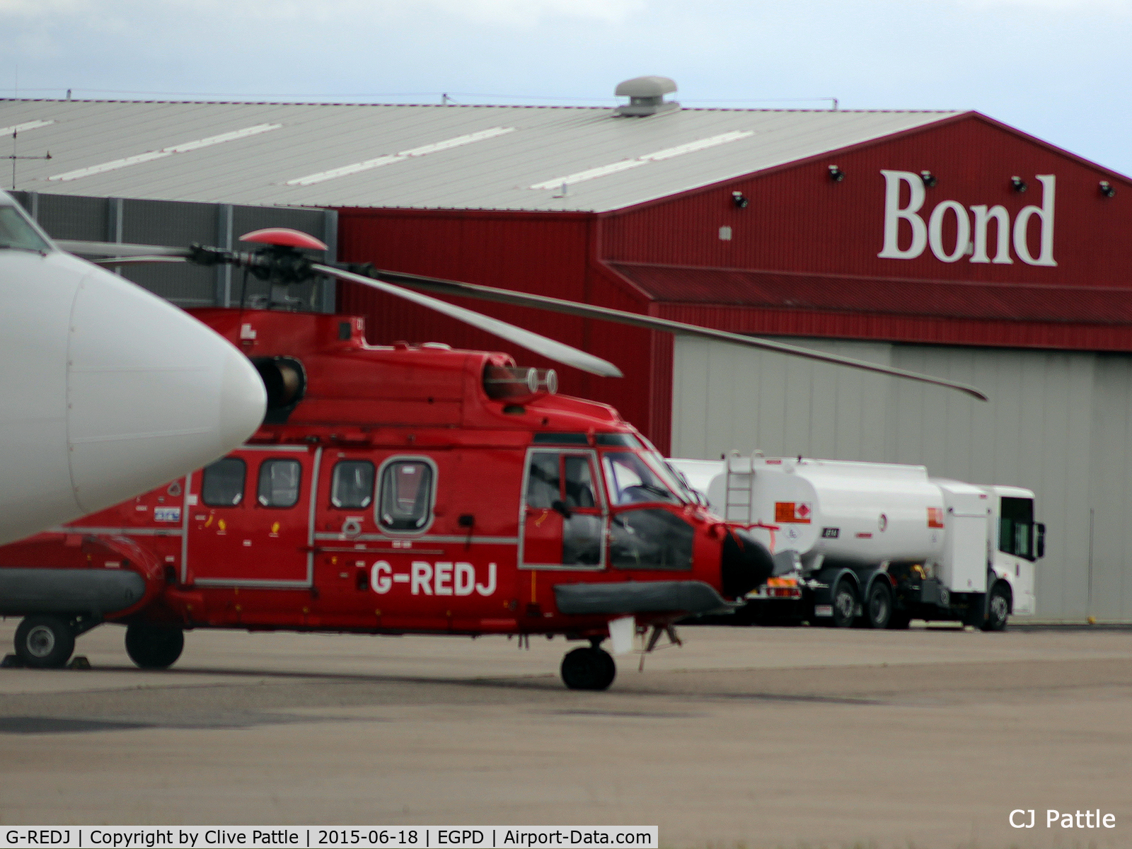 G-REDJ, 2004 Eurocopter AS-332L-2 Super Puma C/N 2608, Hiding behind a B737 cargo at Aberdeen Airport, Scotland EGPD