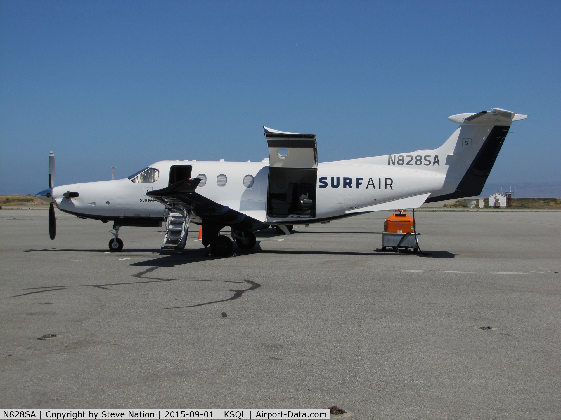 N828SA, 2015 Pilatus PC-12/47E C/N 1525, Surf Airlines 2015 PC-12/47E on ramp @ San Carlos Airport, CA (SF Bay Area terminal) with cargo door open