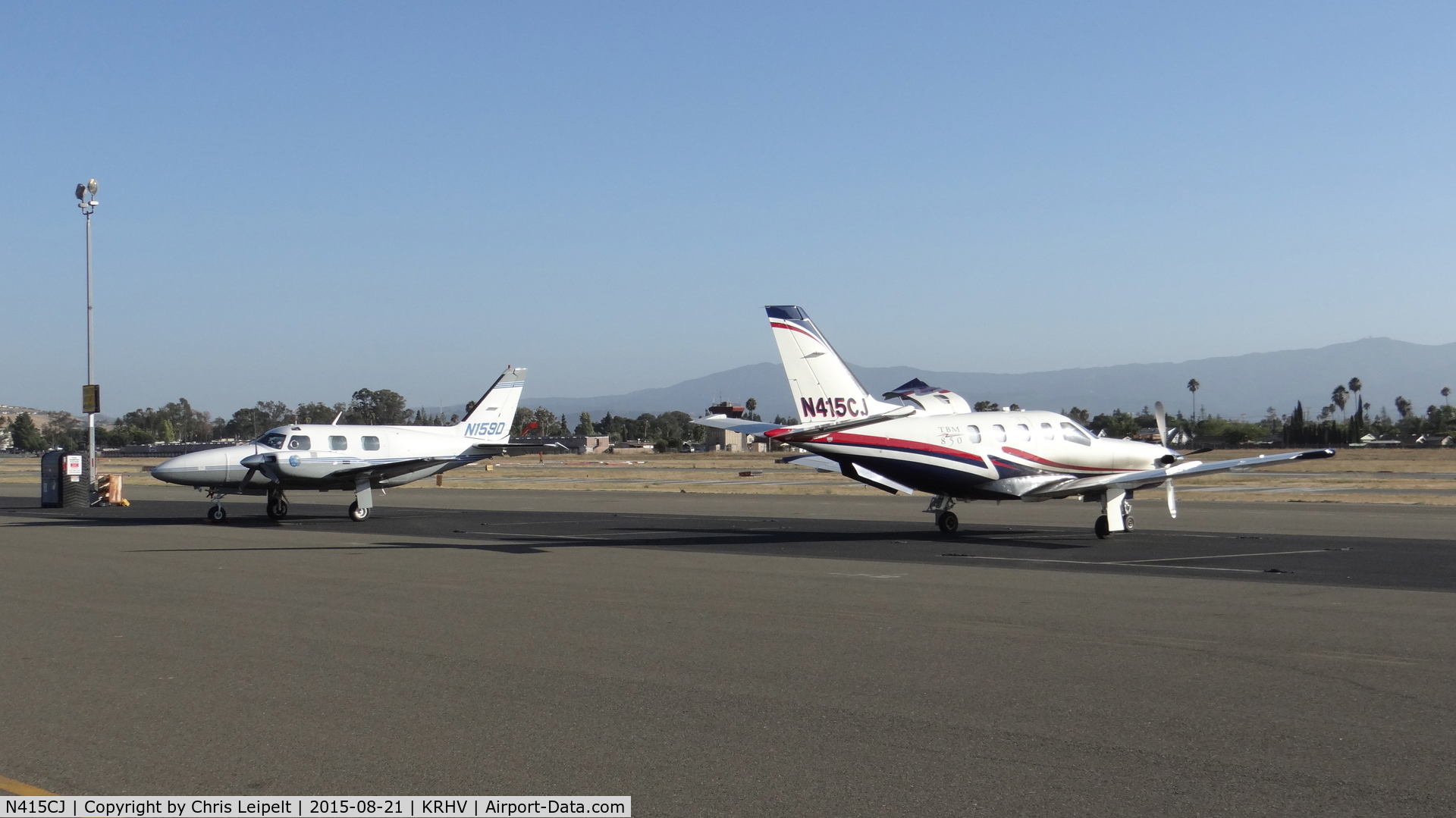 N415CJ, 2007 Socata TBM-700 C/N 415, Stratos Aviation LLC (Los Gatos, CA) 2007 Socata TBM-850 sitting next to a transient Piper Navajo at Reid Hillview Airport, San Jose, CA. Such a beautiful sight to see two rare planes next to each other!