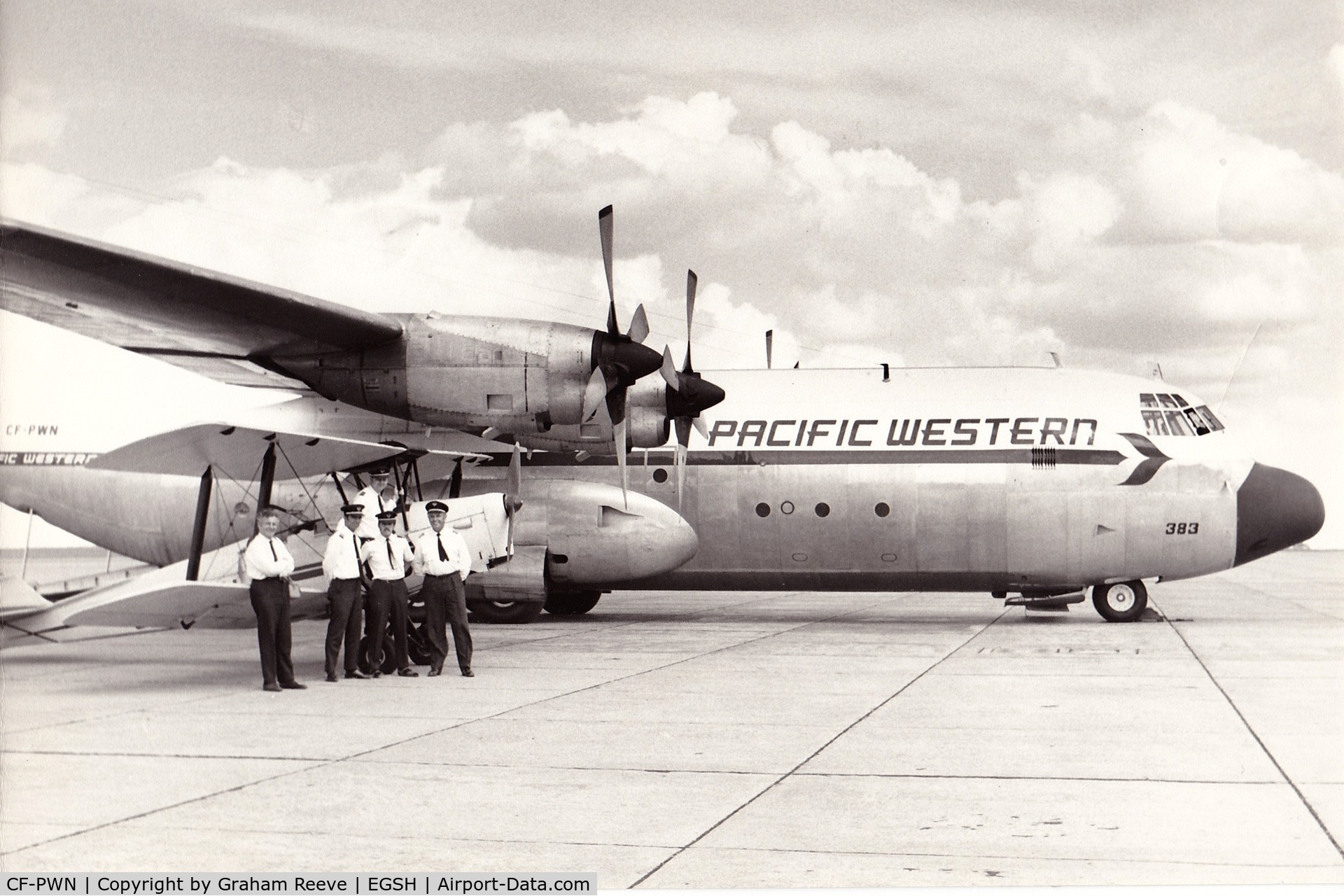 CF-PWN, 1966 Lockheed L-382B Hercules C/N 4129, I recently found this photo of CF-PWN at Norwich. G-ANMV Tiger Moth is pictured with the crew and CFI of the Norfolk and Norwich aero club.