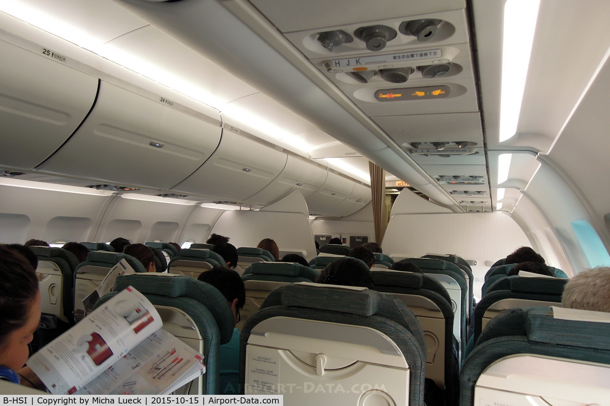 B-HSI, 1999 Airbus A320-232 C/N 0930, Nice clean cabin. Some people struggled with the electronic overhead lockers... (NGB-HKG)