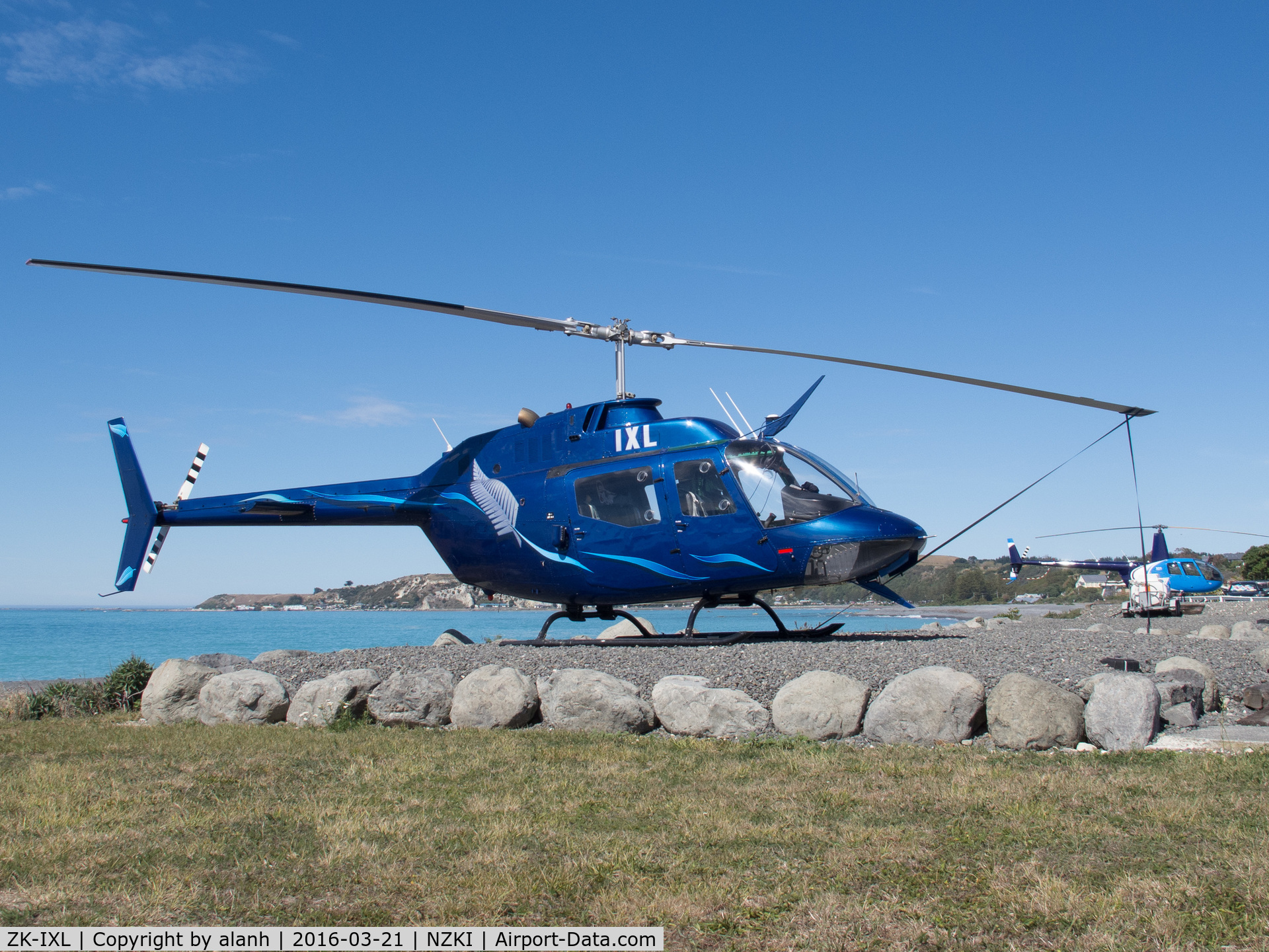 ZK-IXL, 1972 Bell OH-58A Kiowa (206A-1/CH-136) C/N 44062, Off airport, near Kaikoura Helicopters lot on the Kaikoura coast - their R44 ZK-HLE in the background