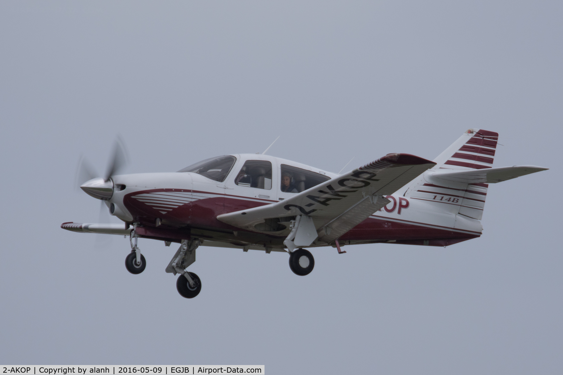 2-AKOP, 1999 Rockwell Commander 114B C/N 14663, Departing Guernsey on a grey, wet day