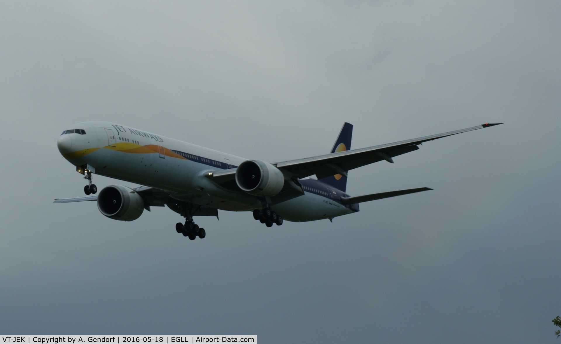 VT-JEK, 2008 Boeing 777-35R C/N 35165/696, Jet Airways, seen here landing at London Heathrow(EGLL), note the thin rainbow on the right of the picture