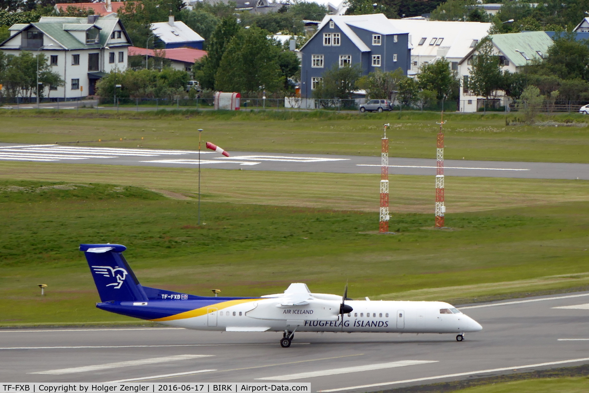 TF-FXB, 2001 De Havilland Canada DHC-8-402Q Dash 8 C/N 4038, The chairman of Icelandic Planespotter Association (IPA) is reported to live in that beautiful blue house next to airport fence...