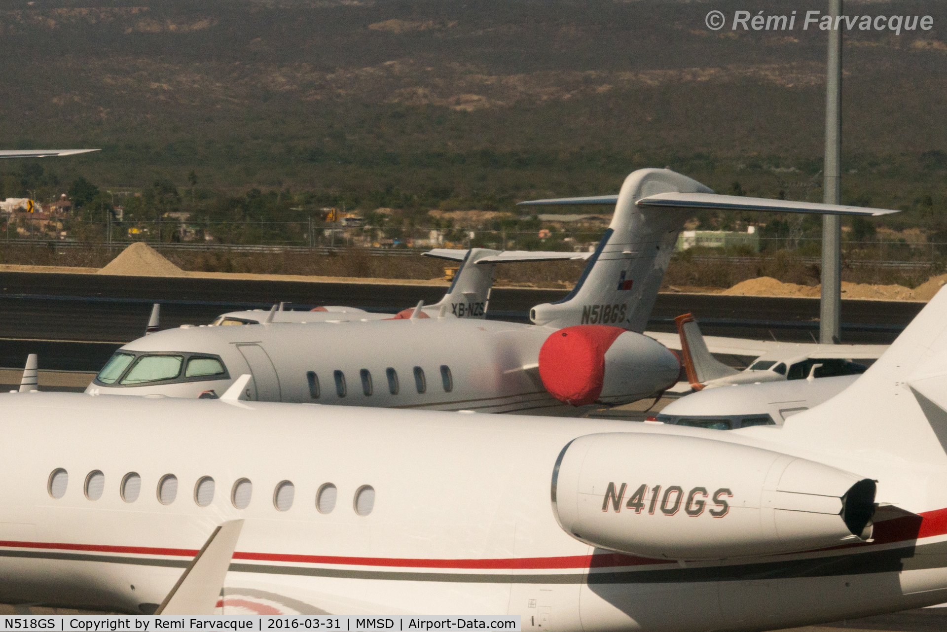 N518GS, 2006 Bombardier Challenger 300 (BD-100-1A10) C/N 20132, Parked north of main terminal building in private craft area. Photo shot from another aircraft.