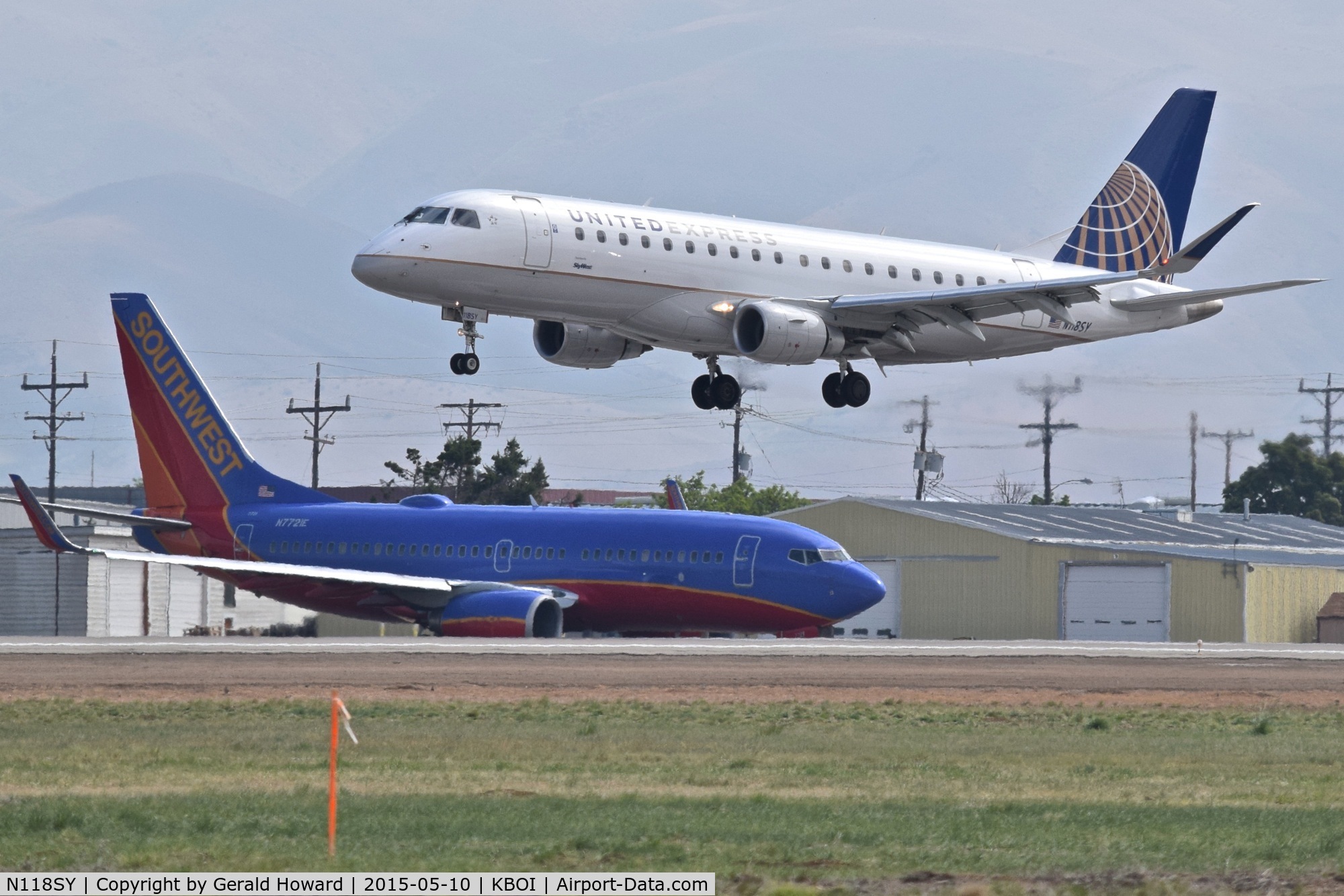 N118SY, 2014 Embraer 175LR (ERJ-170-200LR) C/N 17000420, Landing RWY 28R while Southwest N7721E waits on Alpha.