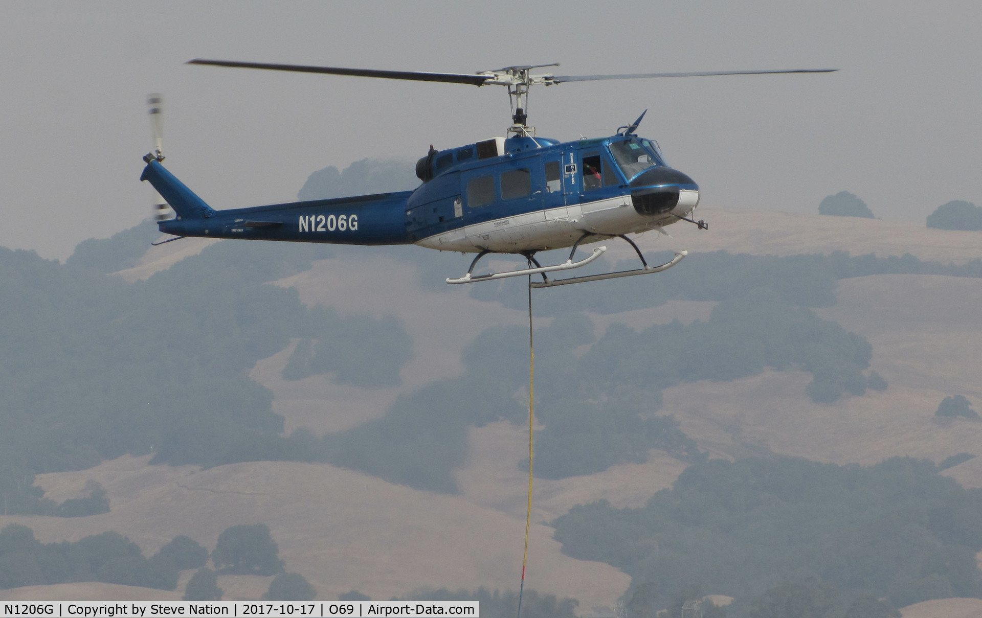 N1206G, 1966 Bell UH-1H Iroquois C/N 5269 (66-0786), Trans Aero (Cheyenne, WY) 1966 Bell UH-1H hovering at Petaluma Municipal Airport, CA temporary home base after making water drops on the devastating October 2017 Northern California wildfires